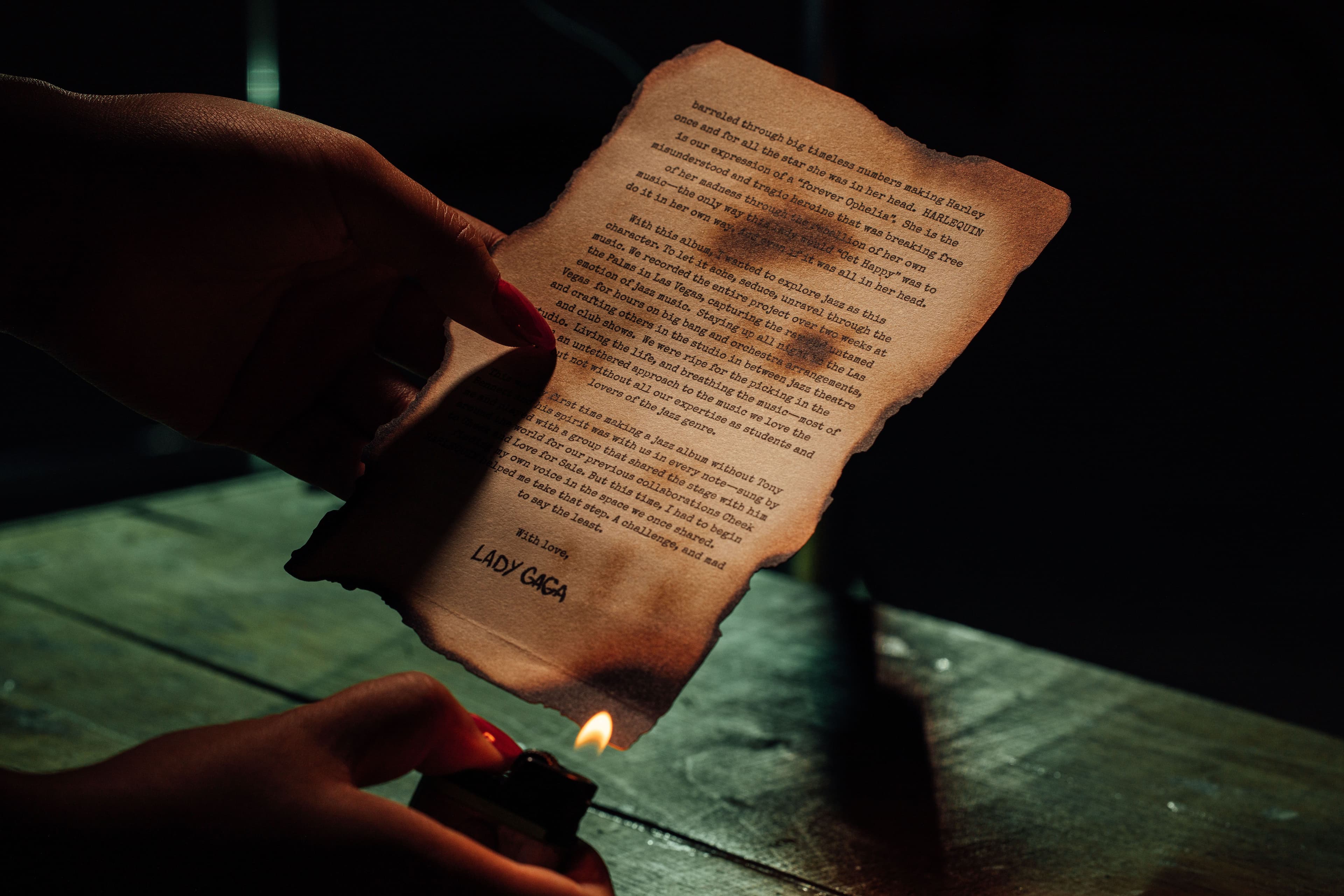 person burning the letter from the Harlequin box